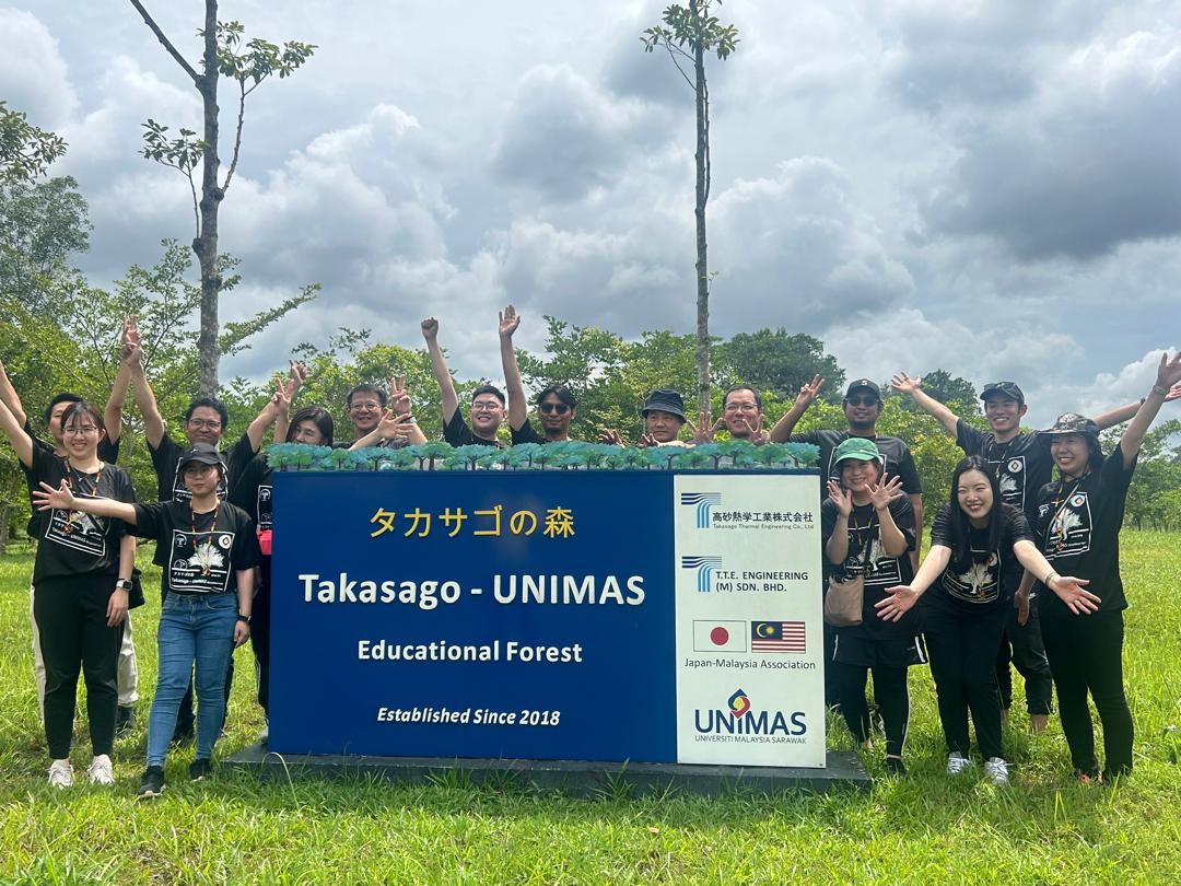 Group photo at the Takasago Forest main signboard on the UNIMAS campus